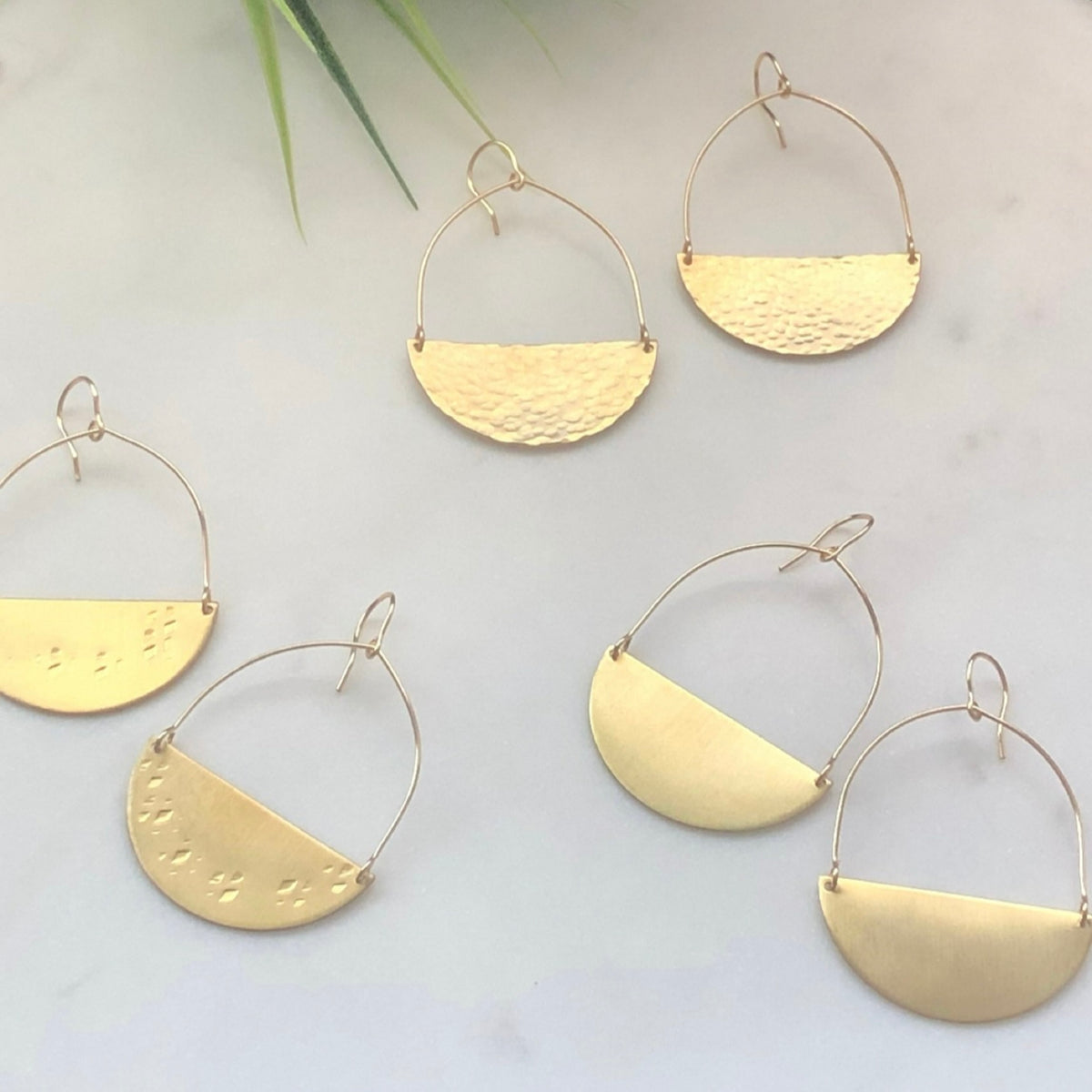 collage of brass half moon earrings in smooth, hammered and textured finish from laurane elisabeth