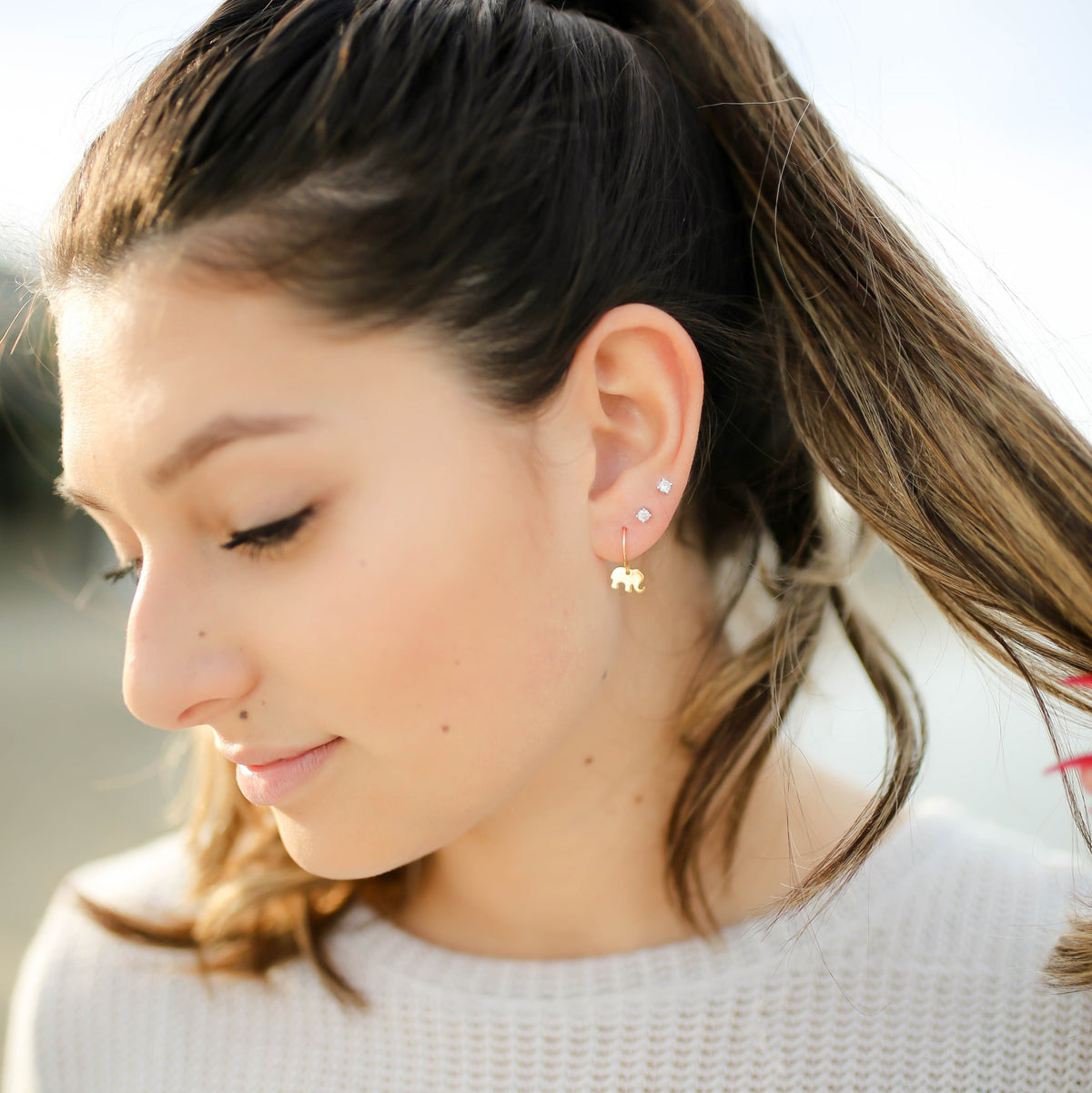 model wearing tiny elephant earrings from laurane elisabeth