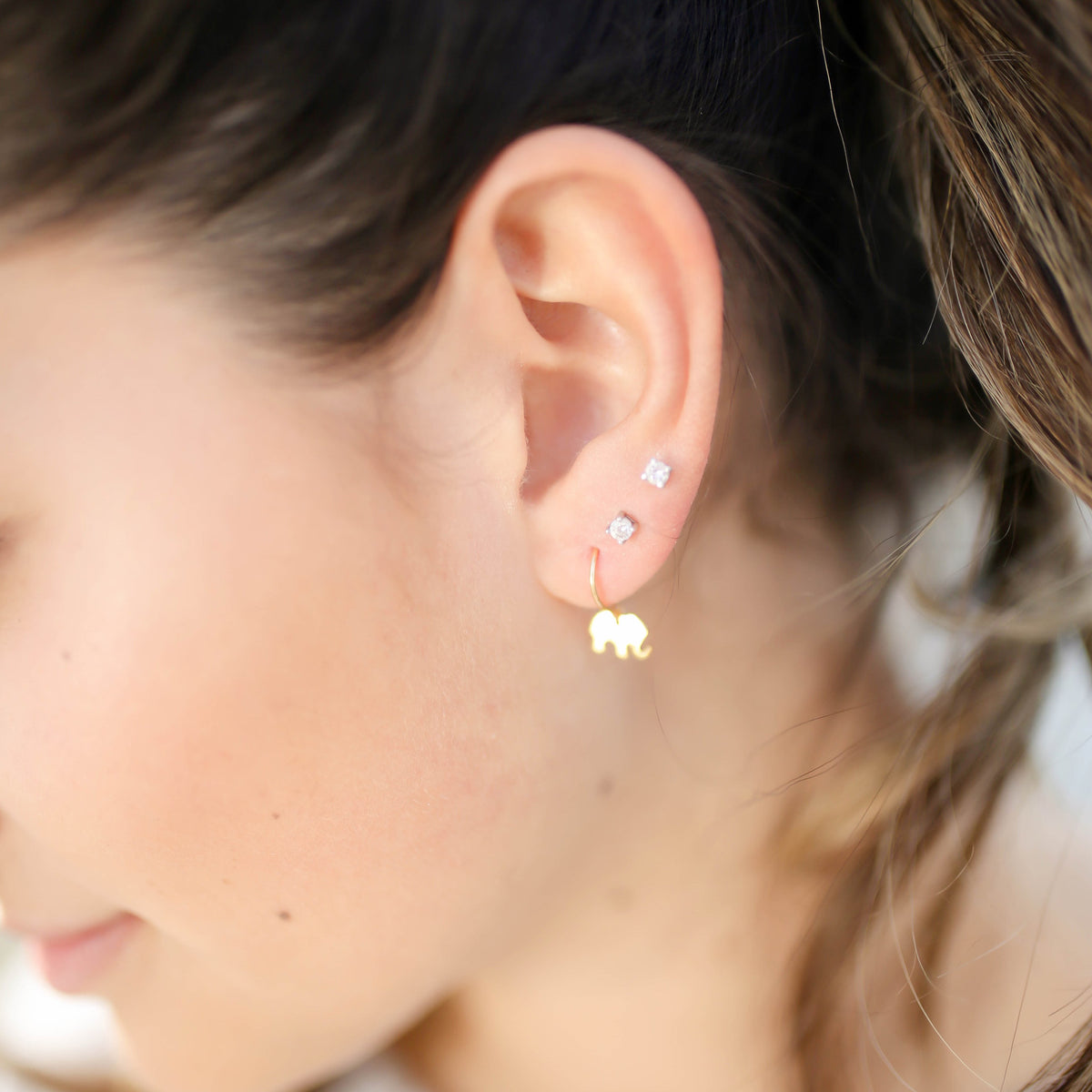 model wearing tiny elephant earrings from laurane elisabeth